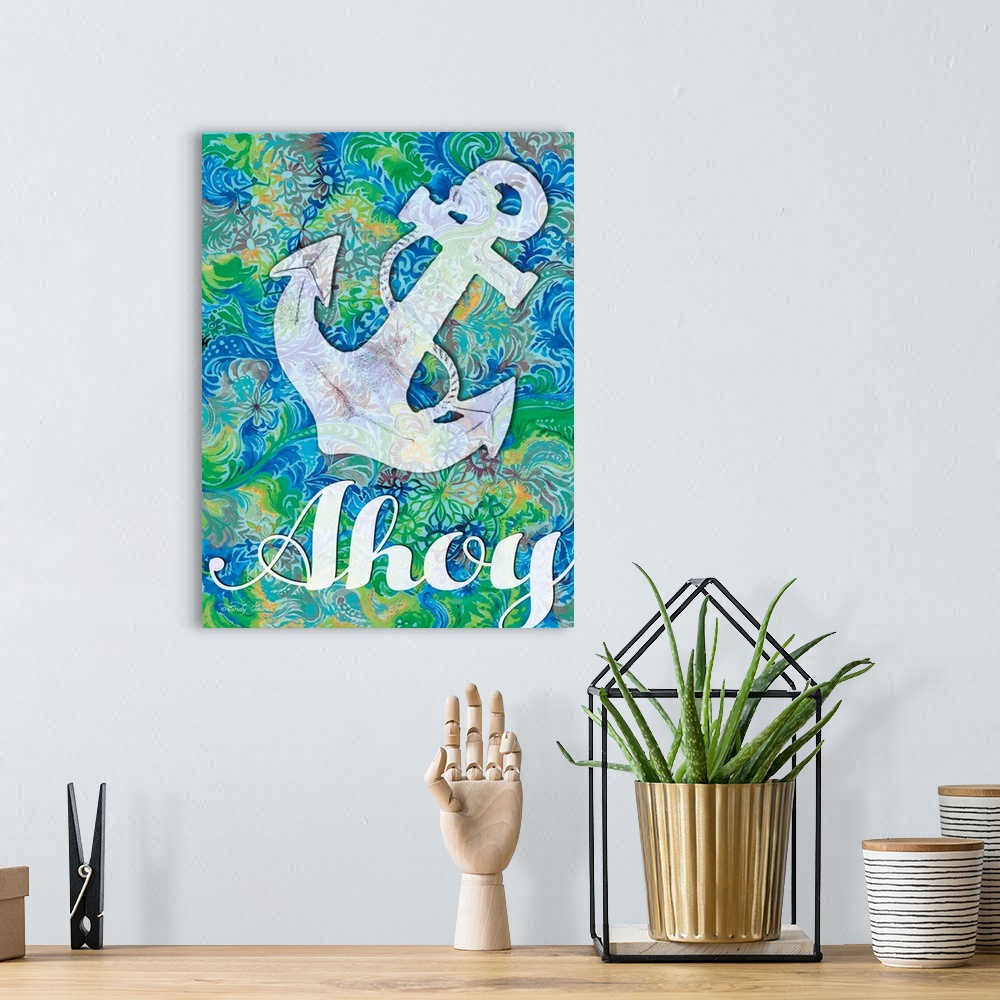 A bohemian room featuring Nautical themed decor artwork of an anchor and the word "Ahoy" on a blue and green patterned back...