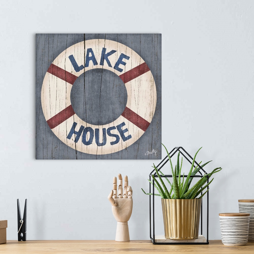 A bohemian room featuring This decorative artwork of a ring buoy features the words, Lake House, over it with a cracked woo...