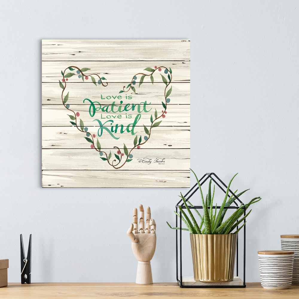 A bohemian room featuring Decorative artwork featuring these words over white shiplap: Love is Patient. Love is kind.