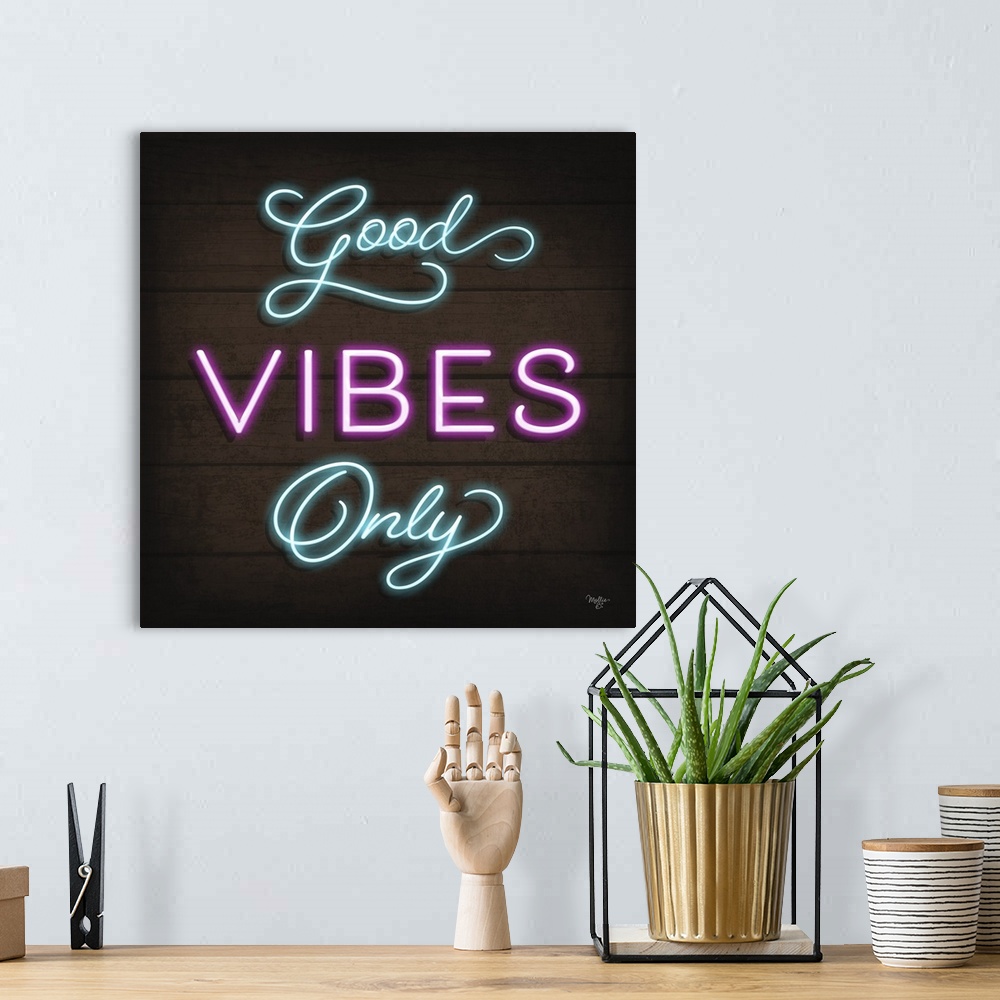 A bohemian room featuring Retro sign resembling neon lights which reads "Good Vibes Only."