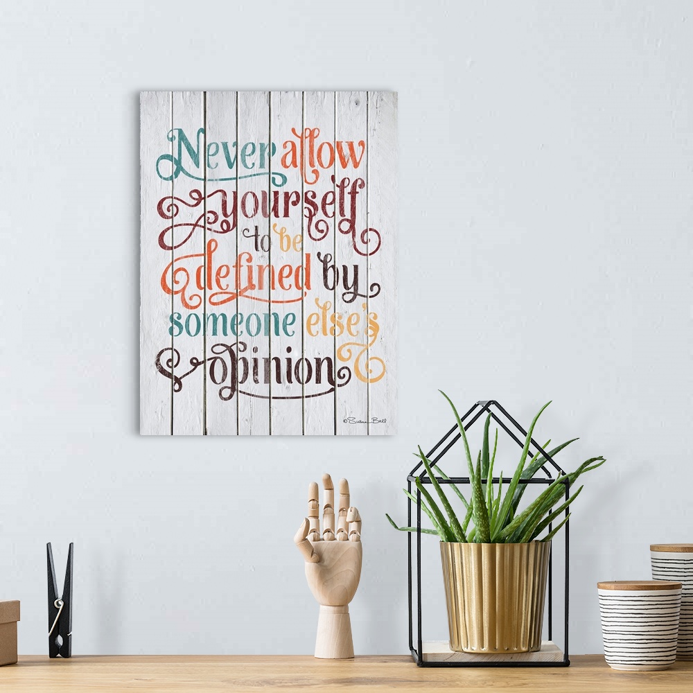 A bohemian room featuring Inspirational quote in text embellished with lots of flourishes and curls, on a wooden board back...