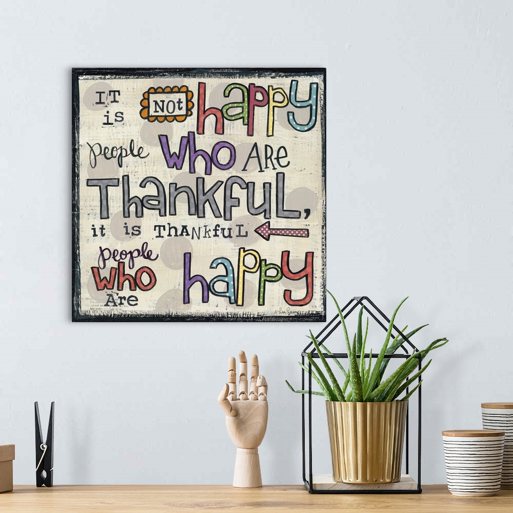 A bohemian room featuring Handwritten typography art reading "It is not happy people who are thankful, it is thankful peopl...