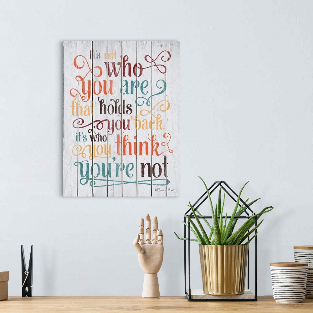 A bohemian room featuring Inspirational quote in text embellished with lots of flourishes and curls, on a wooden board back...
