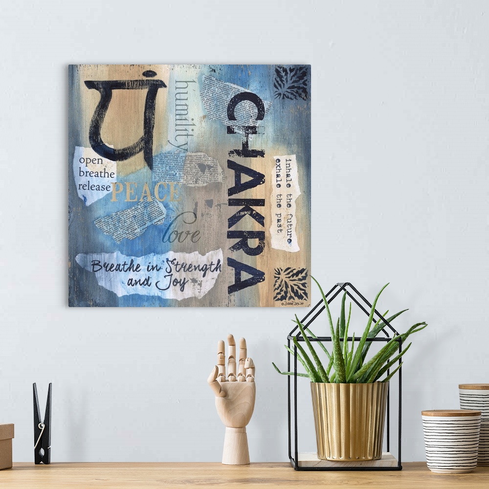 A bohemian room featuring Artwork of yoga-themed words, phrases, and symbols on blue and tan.