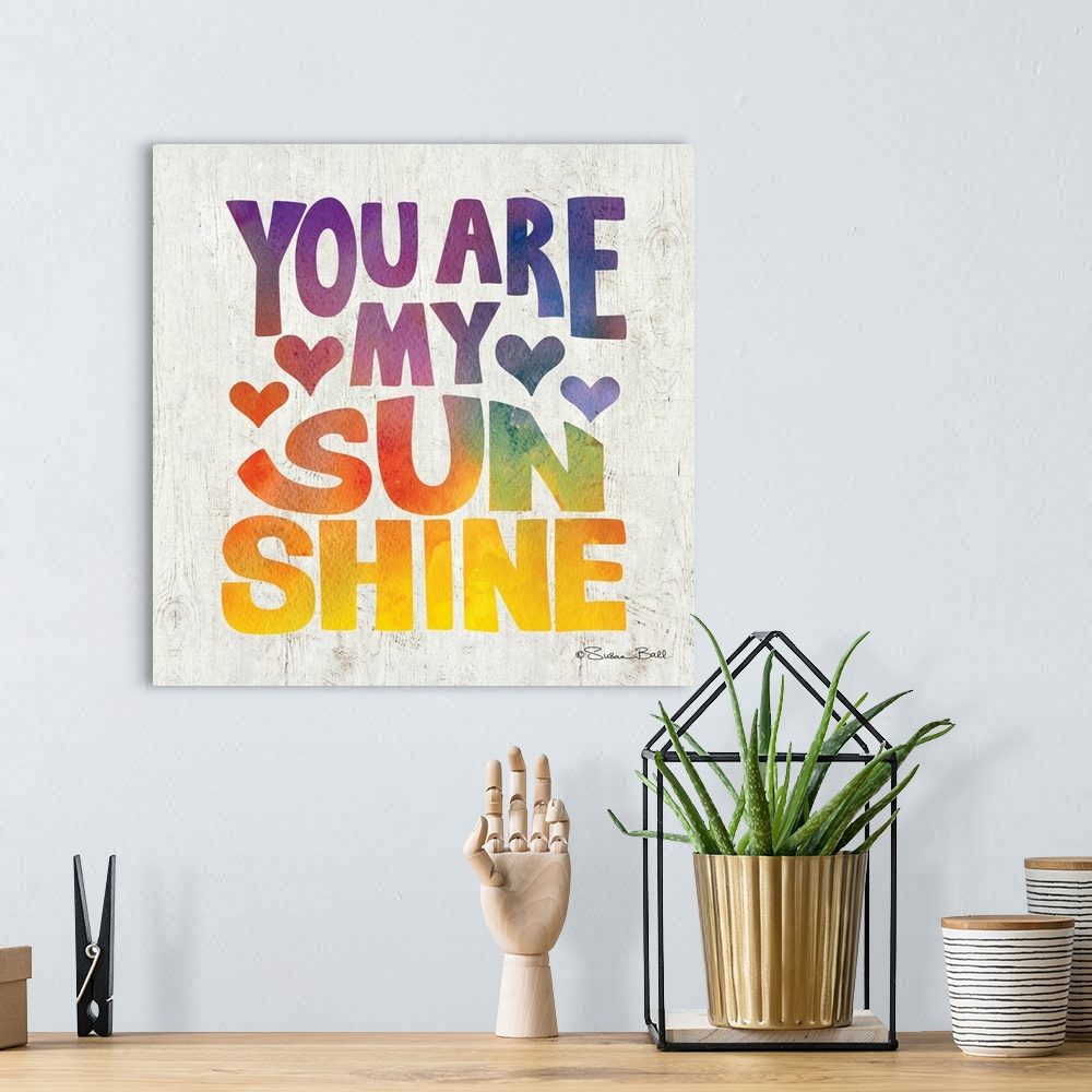 A bohemian room featuring Sweet, loving sentiment in bold lettering in rainbow watercolors.