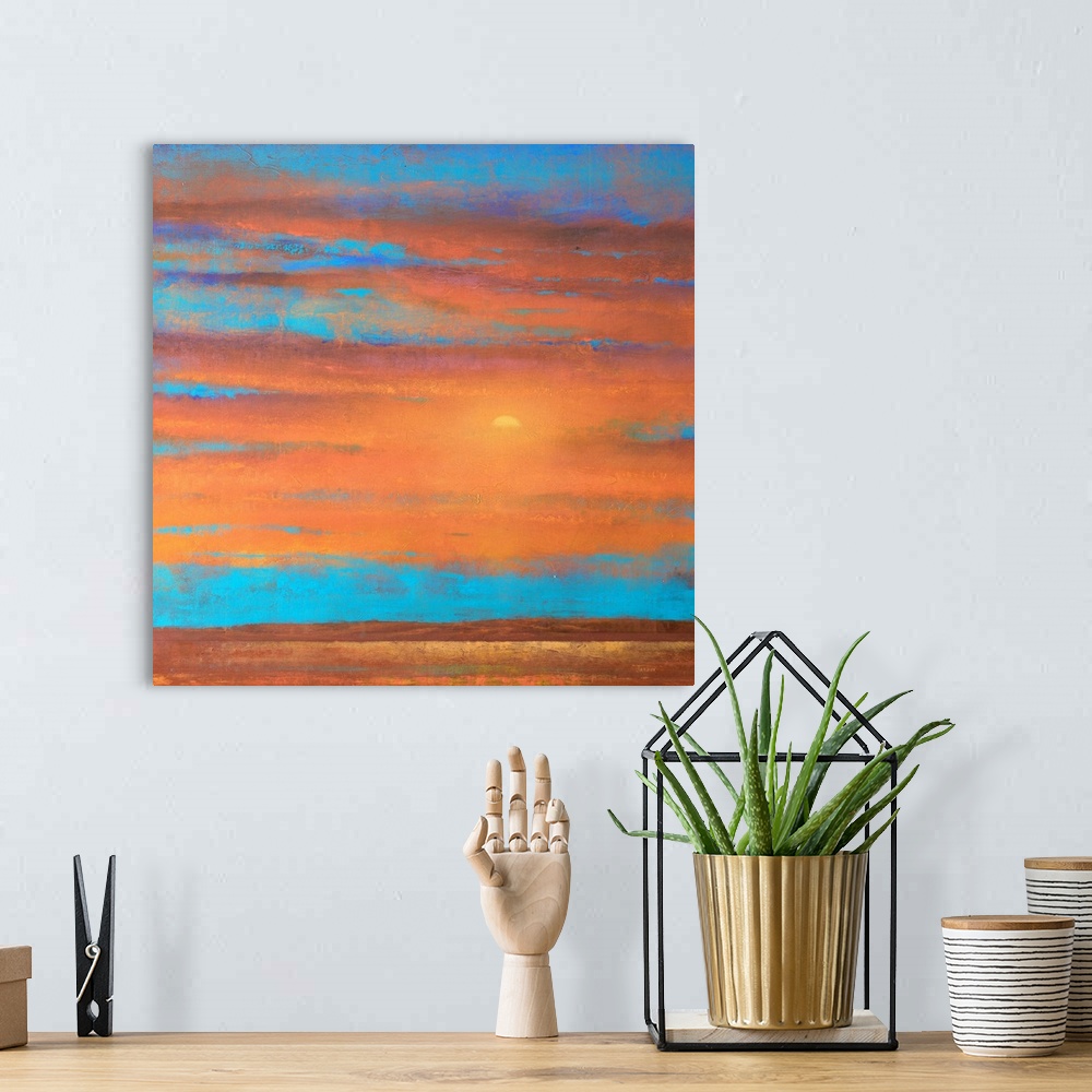 A bohemian room featuring A piece of contemporary artwork that is of a sunset with orange clouds painted on top of a bright...