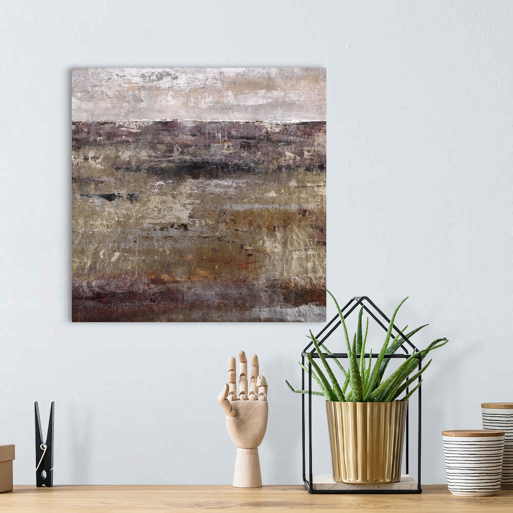A bohemian room featuring Contemporary artwork of a dark landscape in brown under a light grey sky.