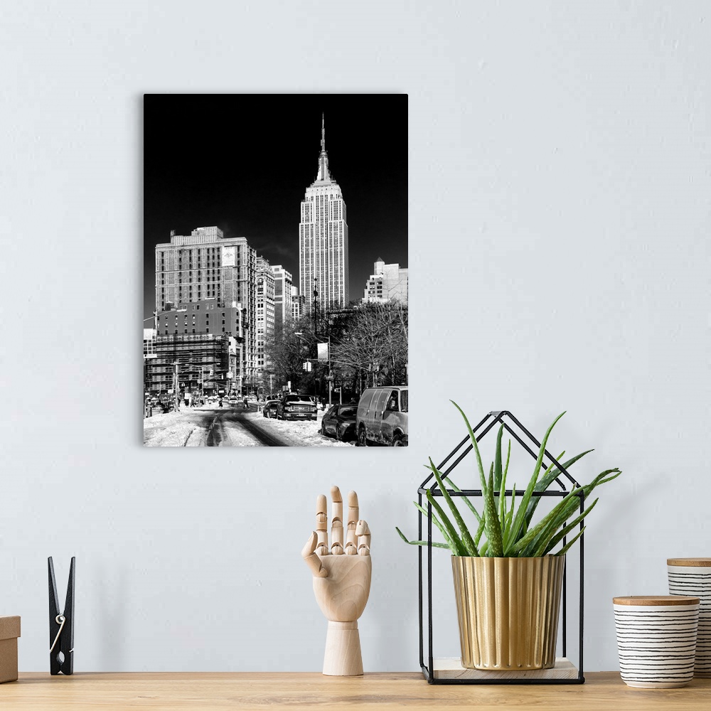 A bohemian room featuring A black and white photograph of the Empire state building standing tall in NYC, seen from street ...