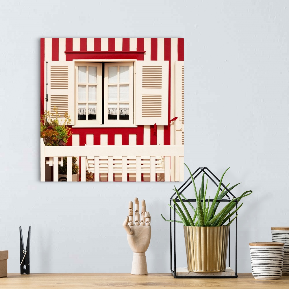 A bohemian room featuring Its' a traditional window with red stripes at Costa Nova Beach in Portugal.