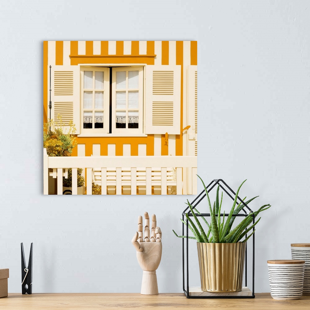 A bohemian room featuring Its' a traditional window with yellow stripes at Costa Nova Beach in Portugal.