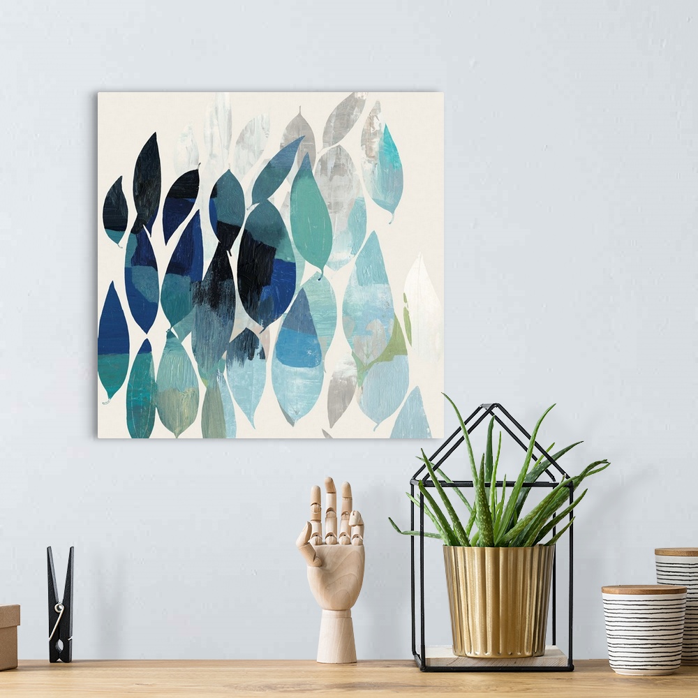 A bohemian room featuring Square abstract painting of leaves in shades of blue.
