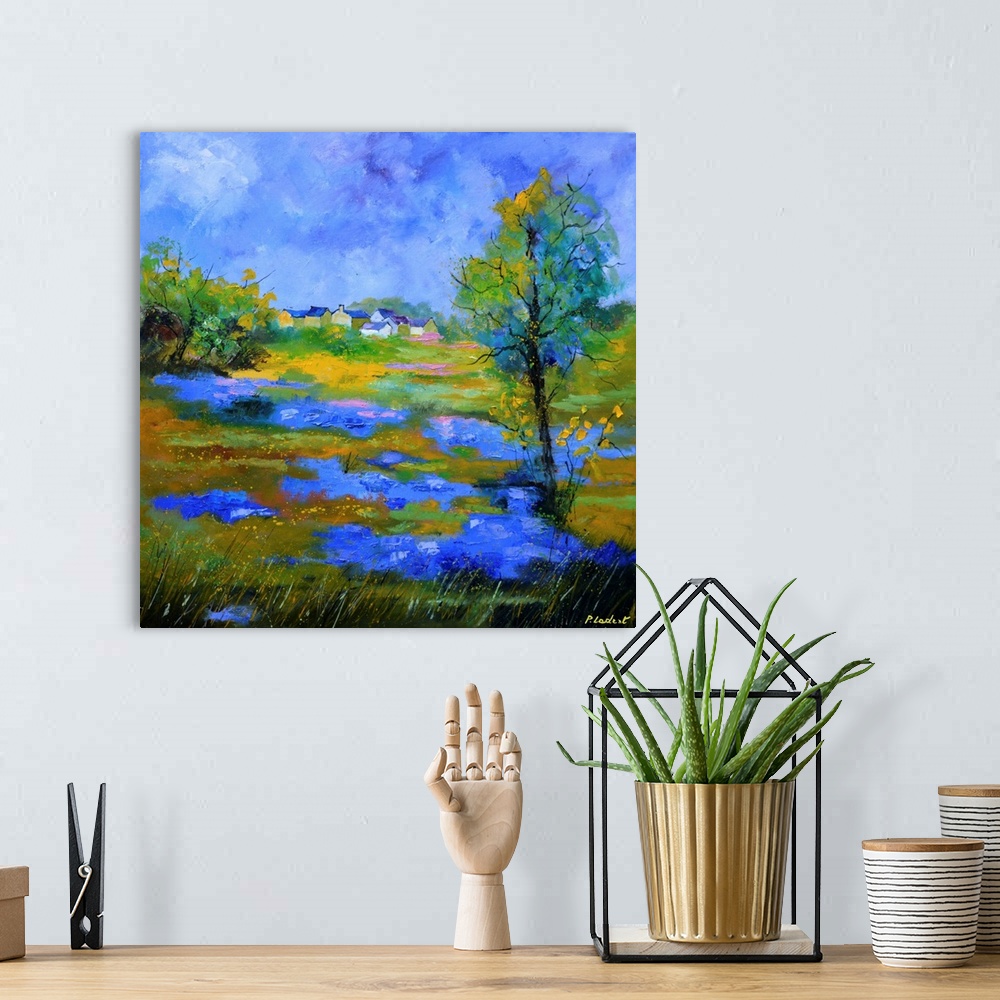 A bohemian room featuring Contemporary landscape painting of a field of blue cornflowers.