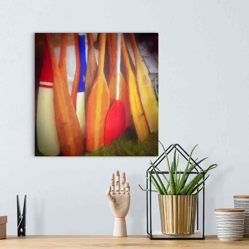 A bohemian room featuring Square contemporary painting of bright, colorful boat oars leaning together.