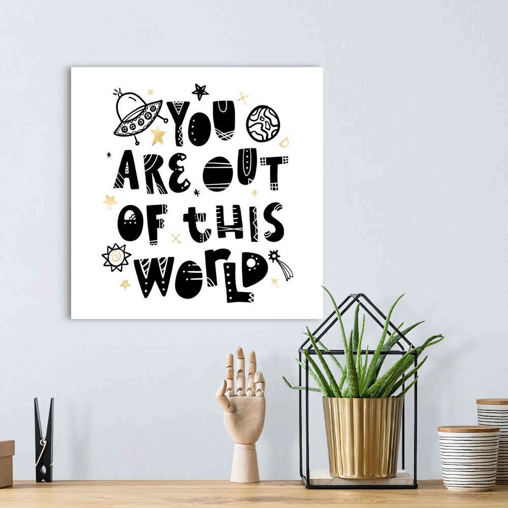 A bohemian room featuring "You Are Out Of This World" in an artistic font with stars and planets on a white background and ...
