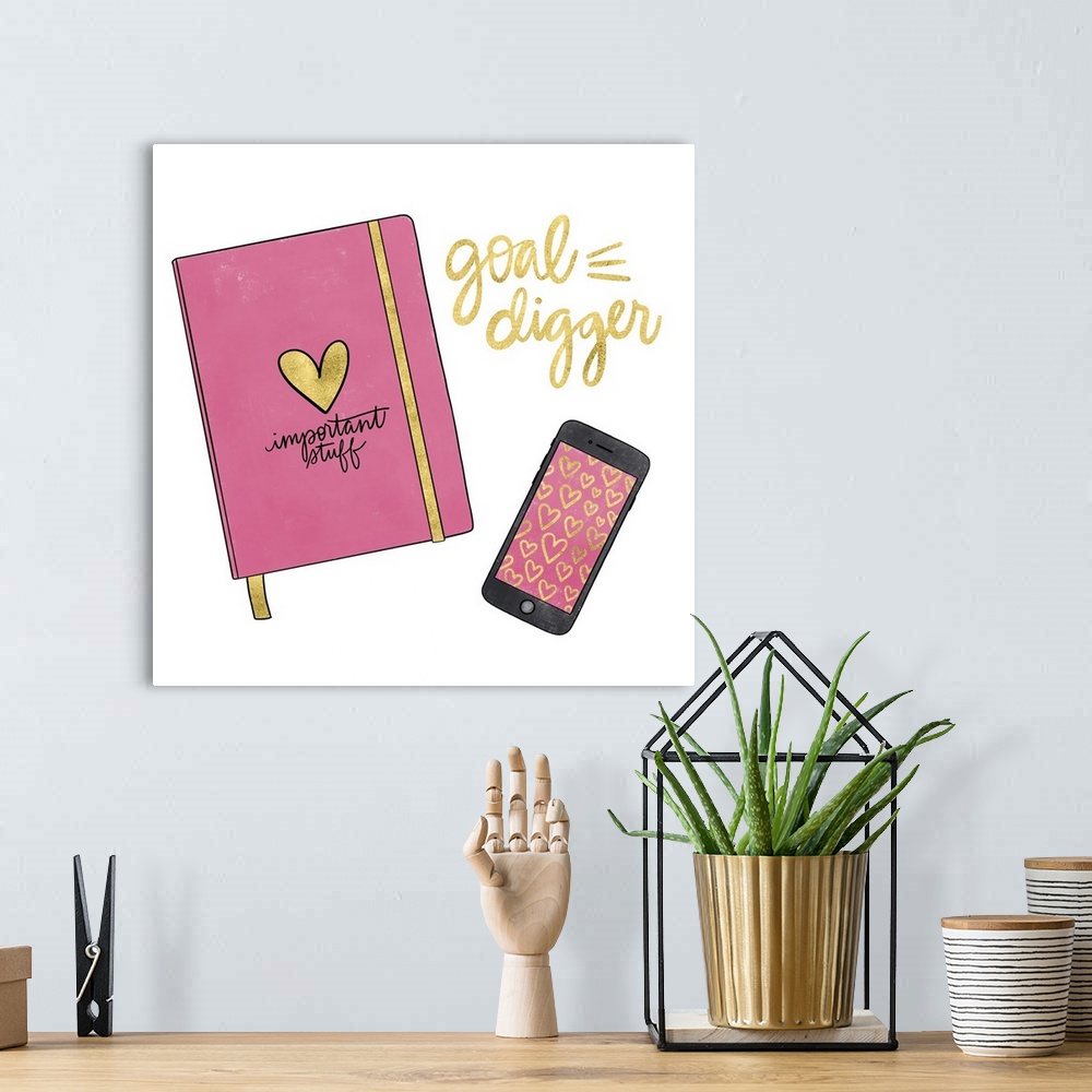 A bohemian room featuring A feminine decorative design of a planner and cell phone with "Goal Digger" in metallic gold.