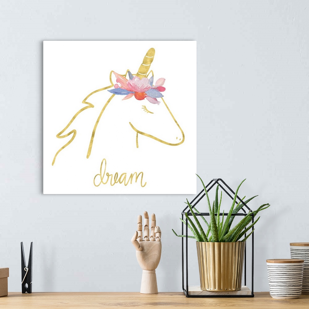 A bohemian room featuring "Dream" with a drawing of an unicorn in gold with colorful flowers on top of it's head.