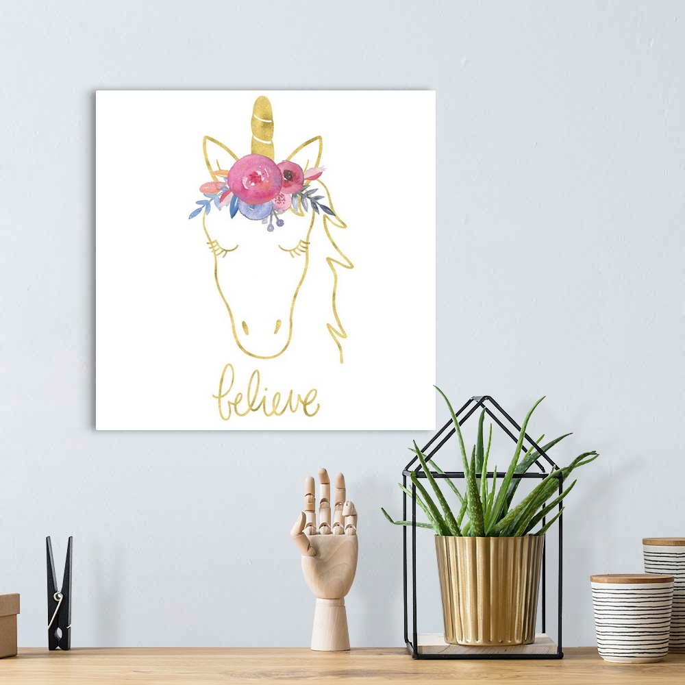 A bohemian room featuring "Believe" with a drawing of an unicorn in gold with colorful flowers on top of it's head.