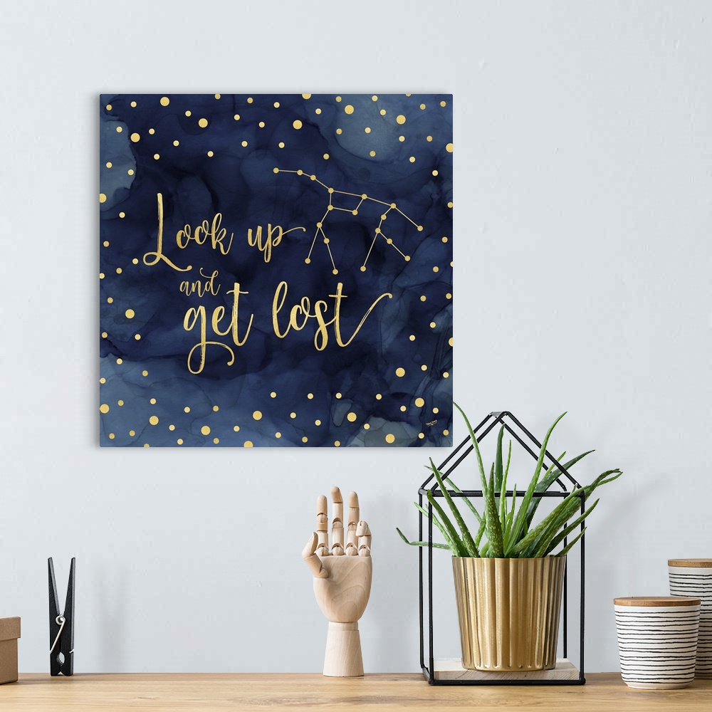 A bohemian room featuring "Look up and get lost" on a blue water-colored background with gold spots.