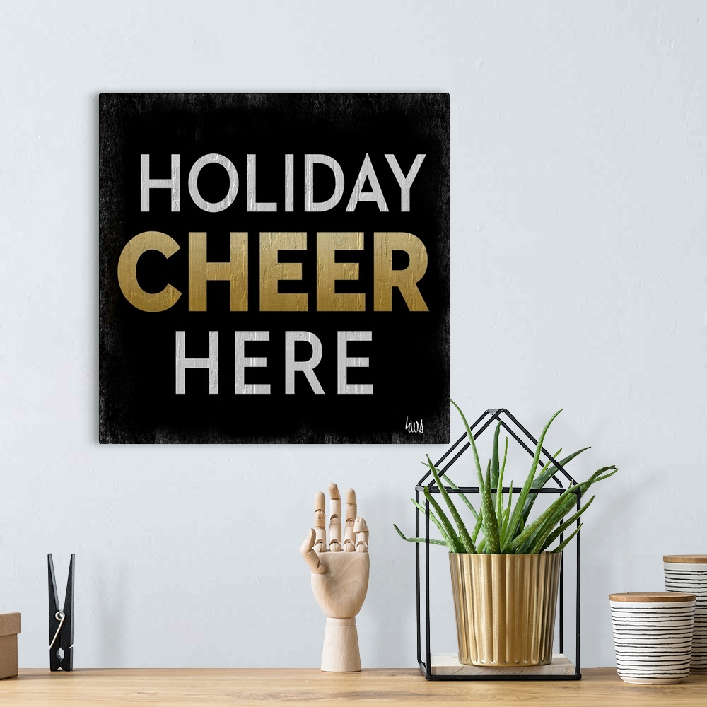 A bohemian room featuring "Holiday Cheer Here" on a black background with roughen edges.