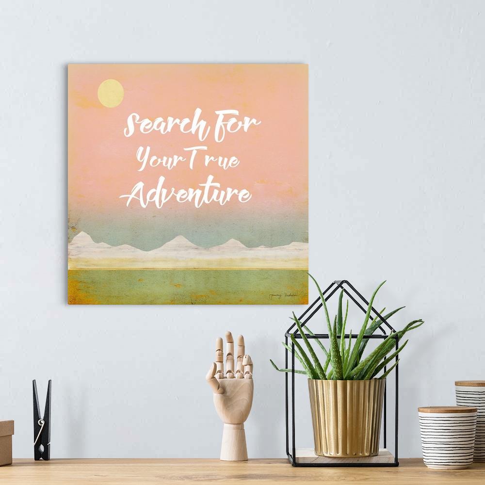 A bohemian room featuring "Search For Your True Adventure" in white with a mountain landscape with a pink sky.