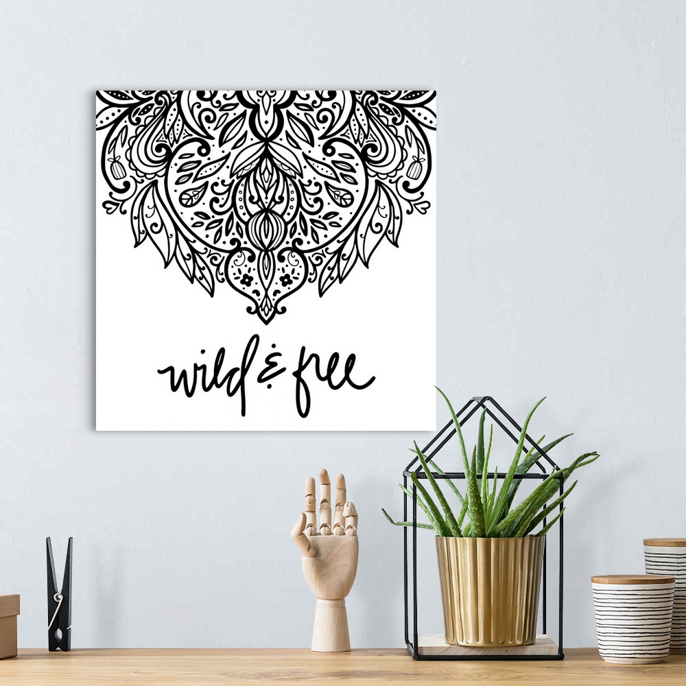 A bohemian room featuring "Wild & Free" with a elaborate mandala design in black on a white background.