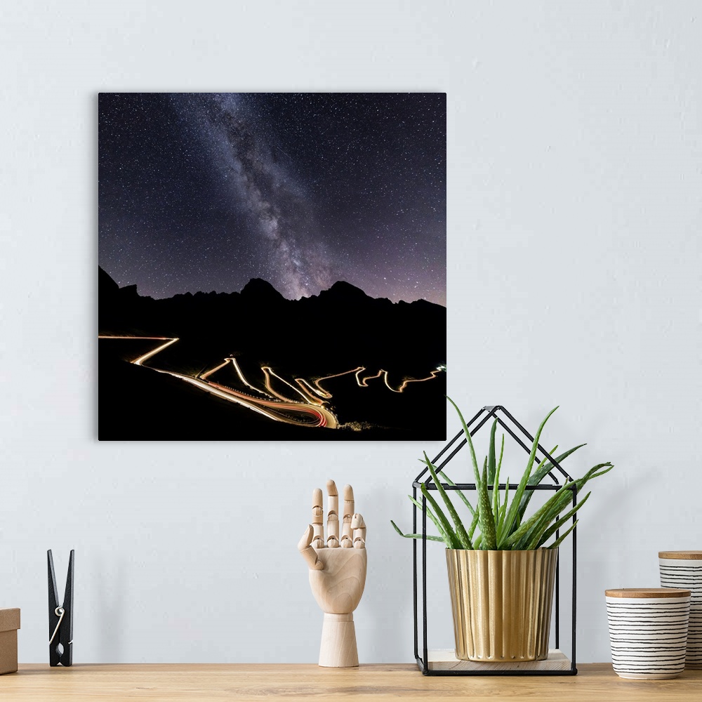 A bohemian room featuring Panorama of the Milky Way and lights of car trace at Stelvio Pass, Valtellina, Lombardy, Trentino...