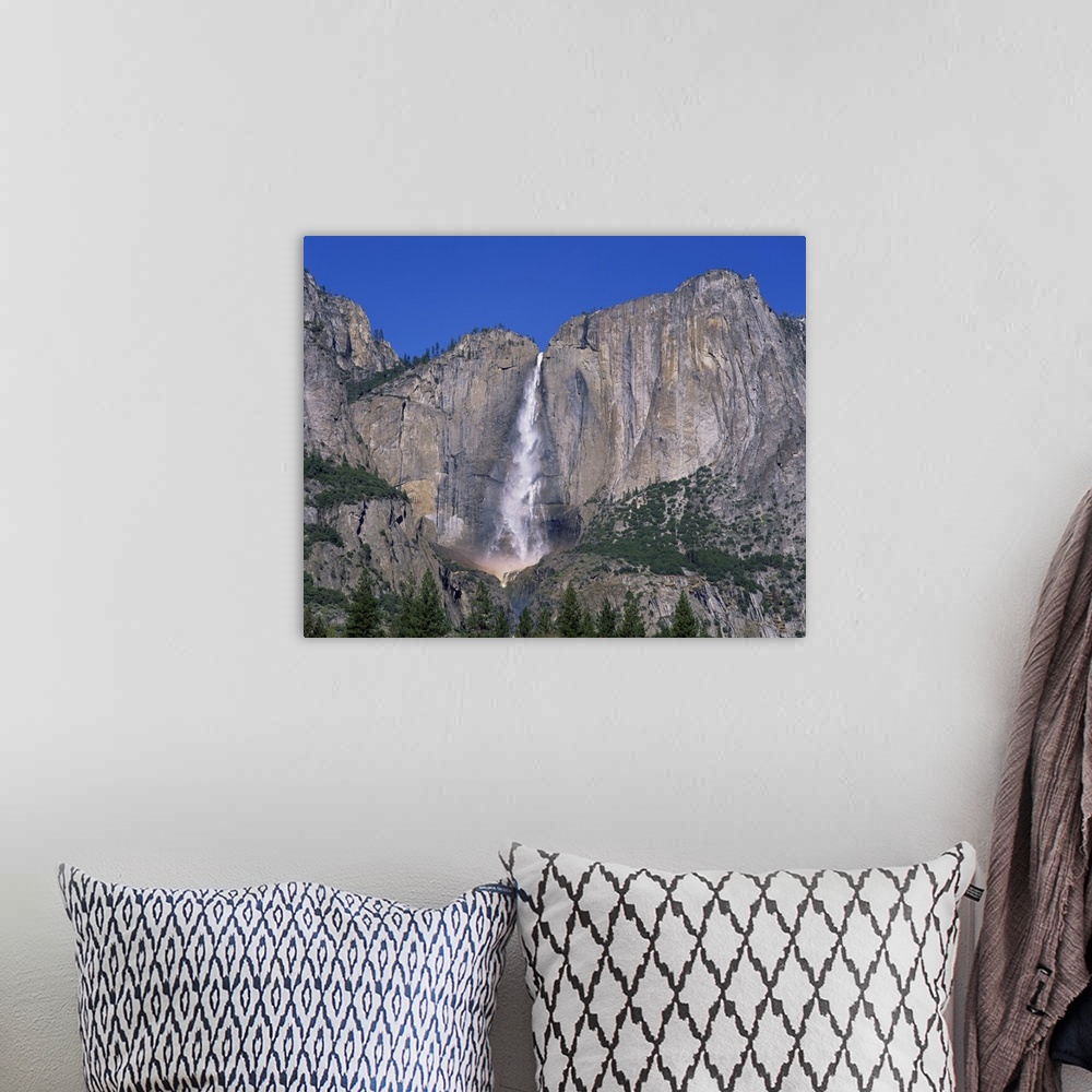 A bohemian room featuring Waterfall cascades over rock wall at Rainbow Falls in the Yosemite Park, California