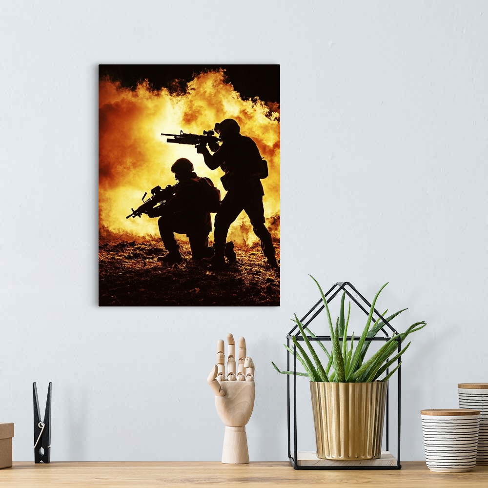 A bohemian room featuring Black silhouettes of a pair of soldiers in the burning fire  during a battle operation.