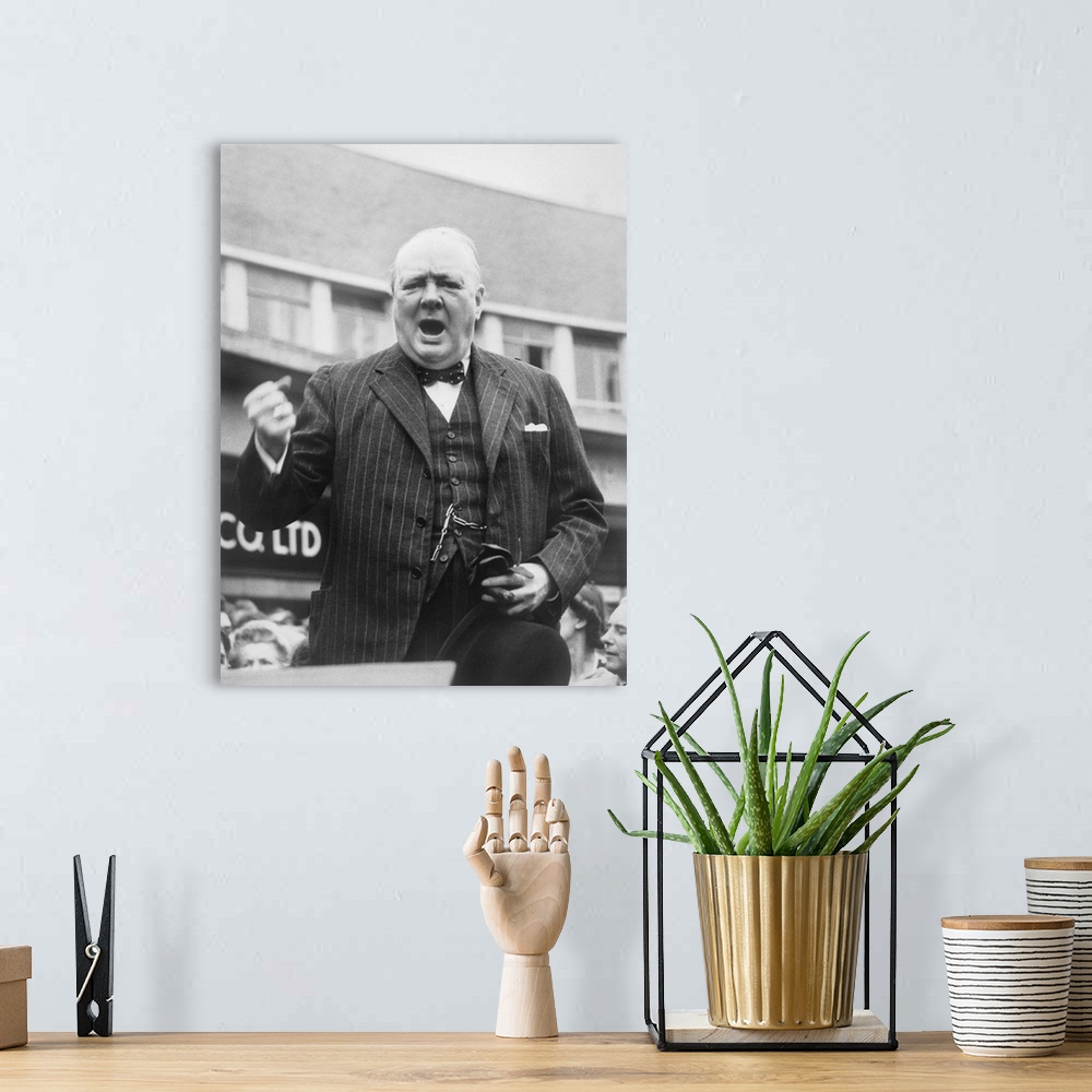 A bohemian room featuring British history photograph of Prime Minister Winston Churchill during an election campaign speech...