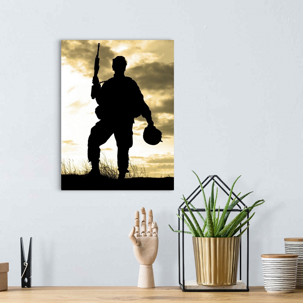 A bohemian room featuring Silhouette of U.S. soldier with rifle against a sunset.