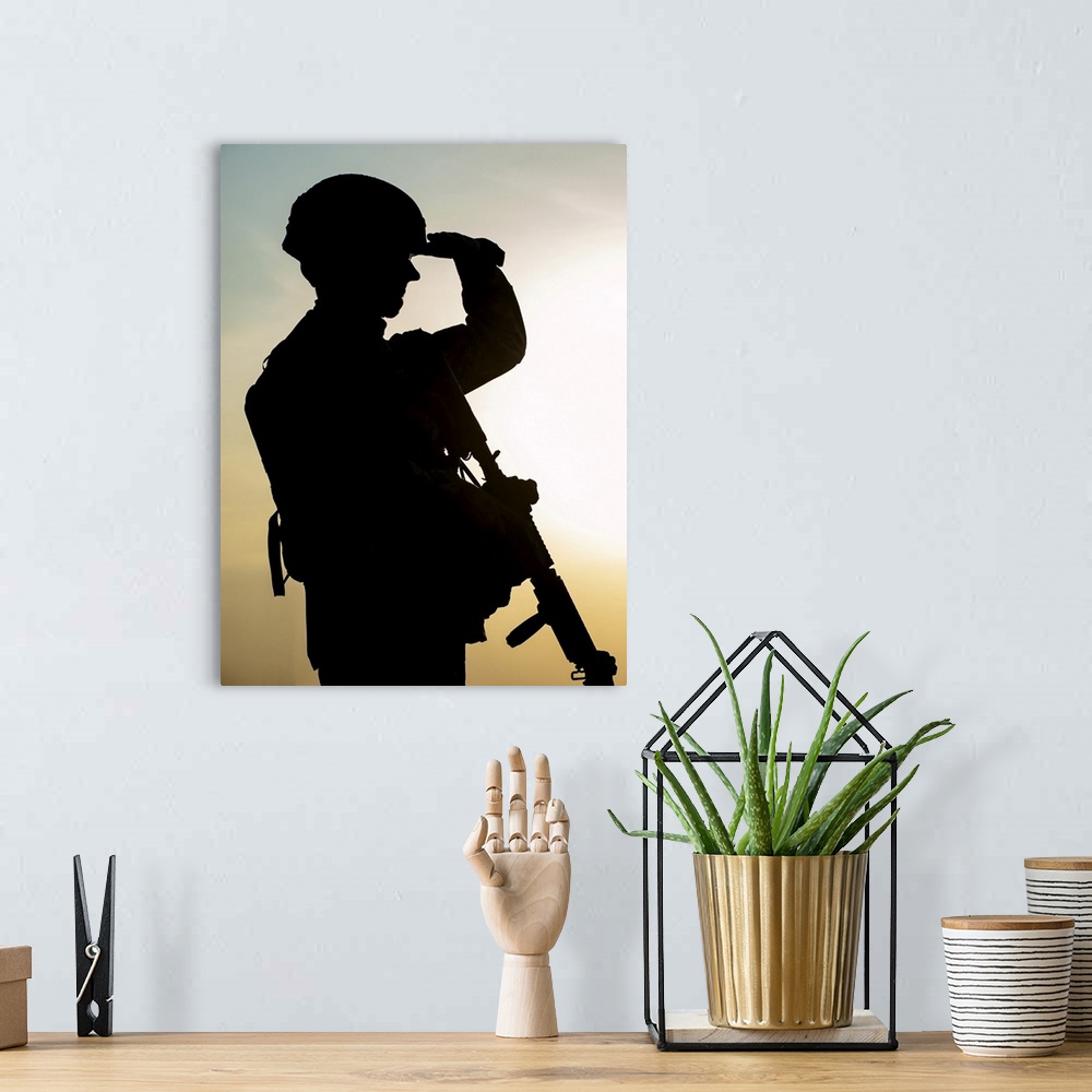 A bohemian room featuring Silhouette of U.S. soldier with rifle against the sunset.