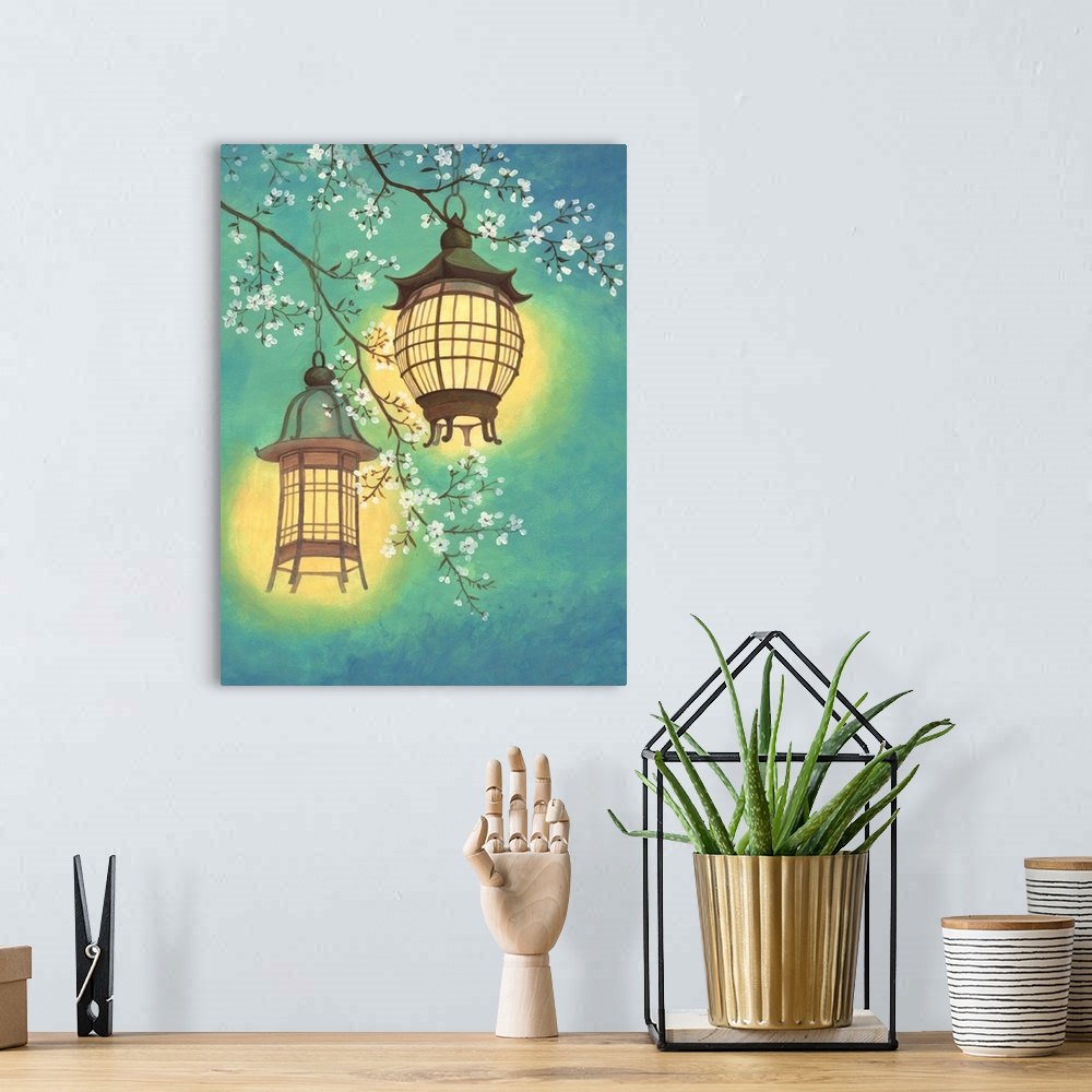 A bohemian room featuring Asian style painting of two lit lanterns hanging in a cherry tree.