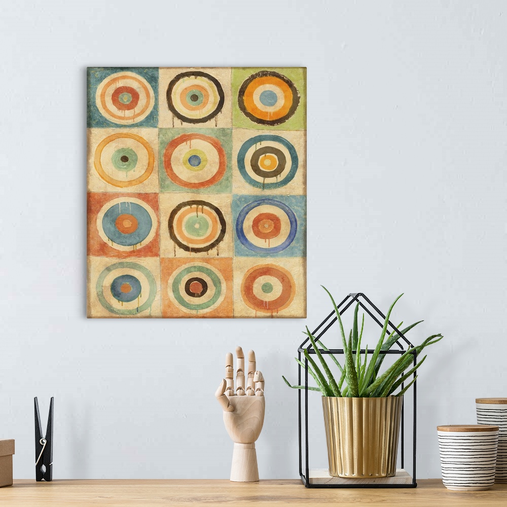 A bohemian room featuring Abstract geometric artwork of multicolored concentric circles.