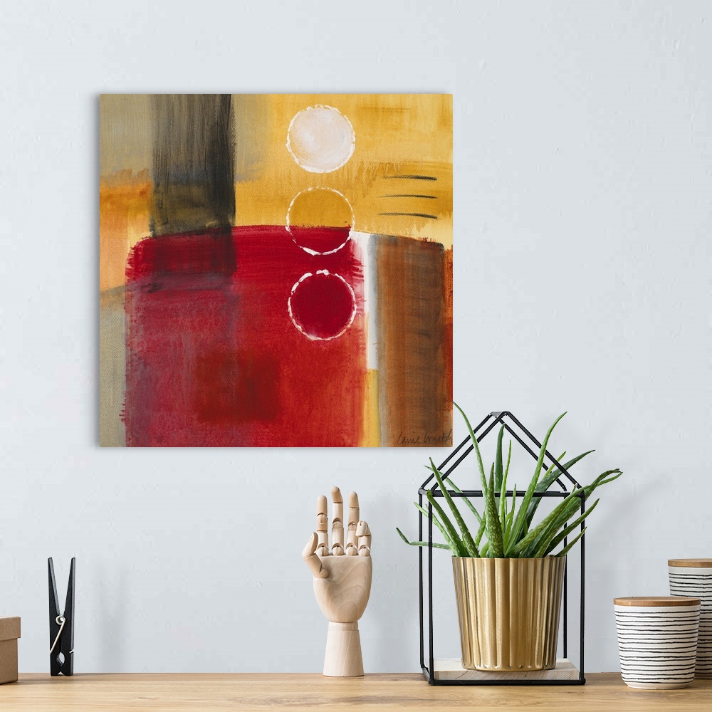 A bohemian room featuring Square abstract painting on a big canvas in primarily warm tones.  A large cylindrical object is ...