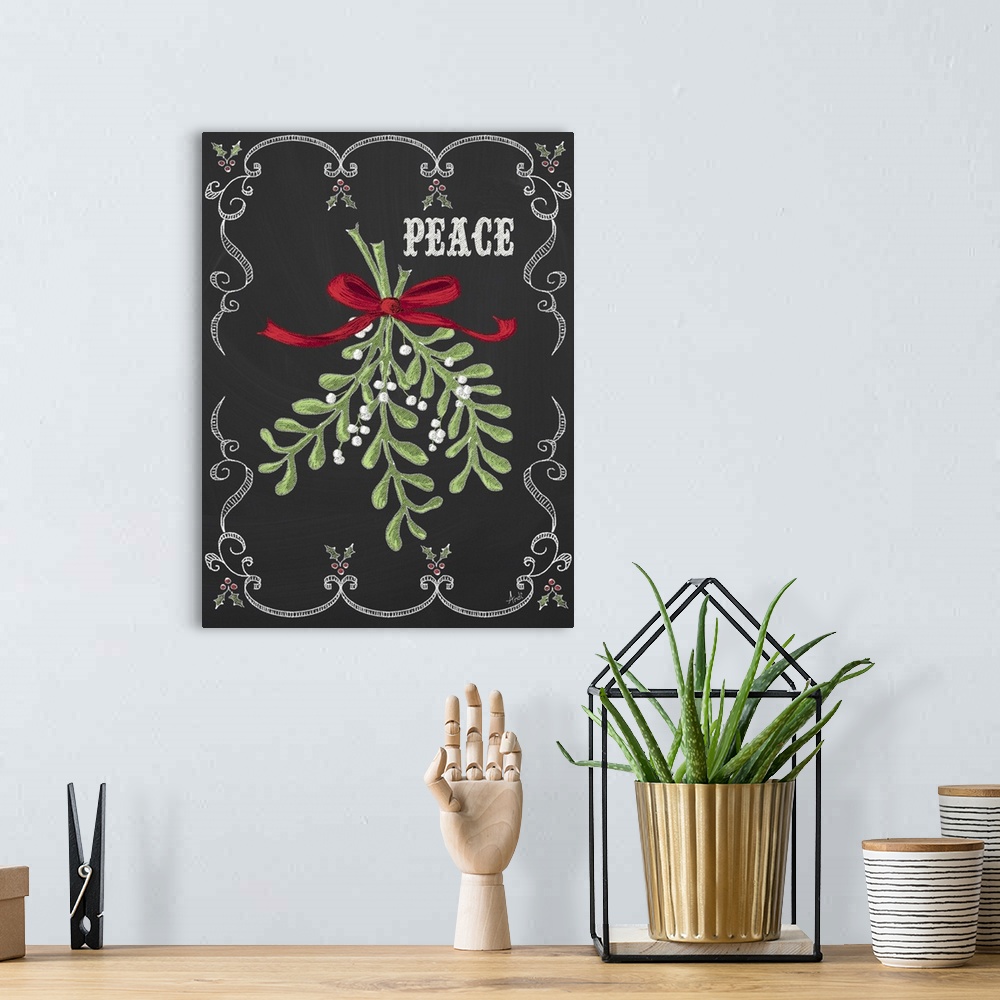 A bohemian room featuring Christmas decor artwork of mistletoe against a black background with white decorative scroll work...