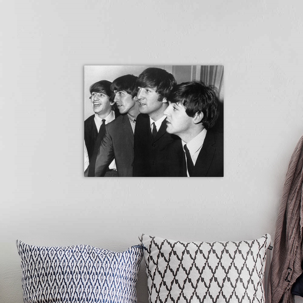 A bohemian room featuring From left to right: Ringo Starr, George Harrison, John Lennon, and Paul McCartney.