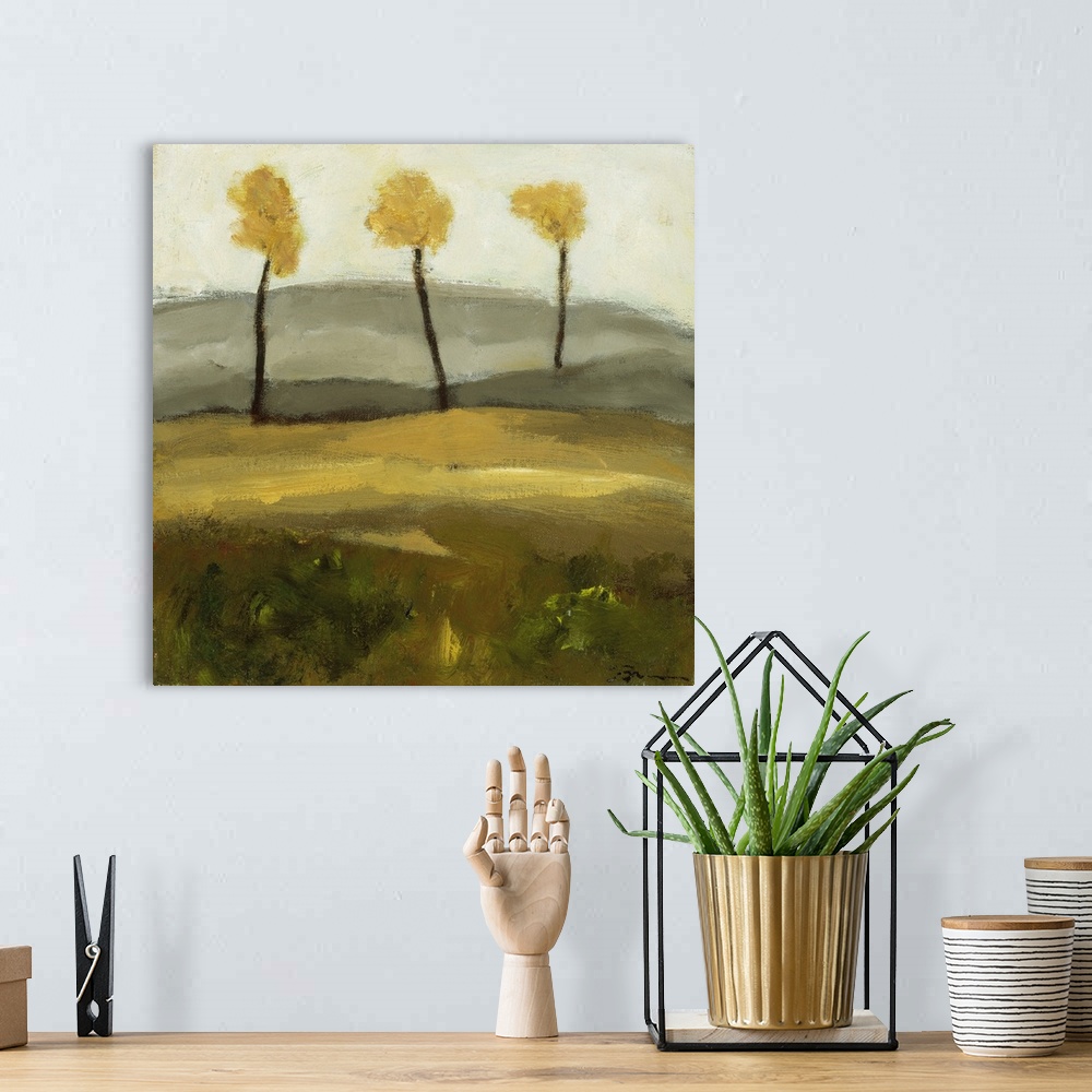 A bohemian room featuring Contemporary landscape painting with three trees in autumn foliage standing together in the dista...