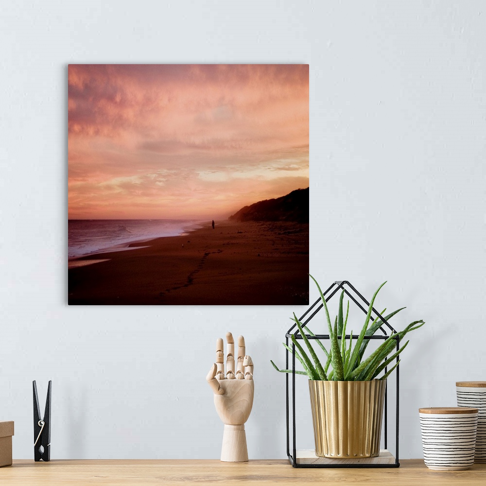 A bohemian room featuring The Australian coast at sunset with a figure in the distance