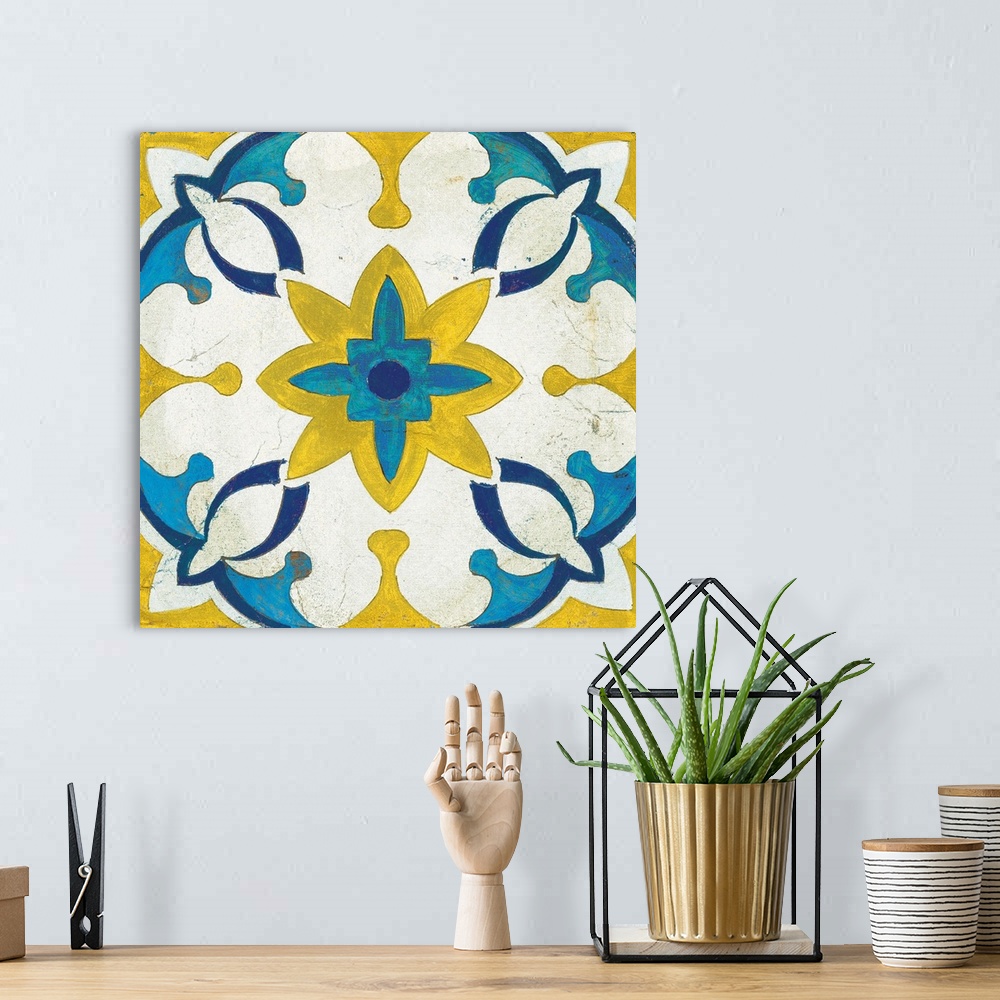 A bohemian room featuring Decorative square painting of a floral tile design in colors of blue, yellow and white.