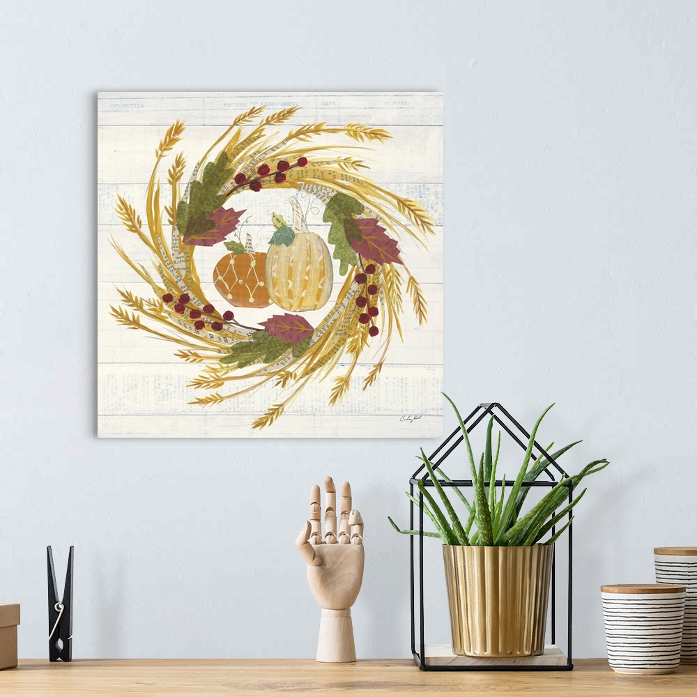 A bohemian room featuring Decorative artwork of a wreath of fall leaves with pumpkins and a white wood background.