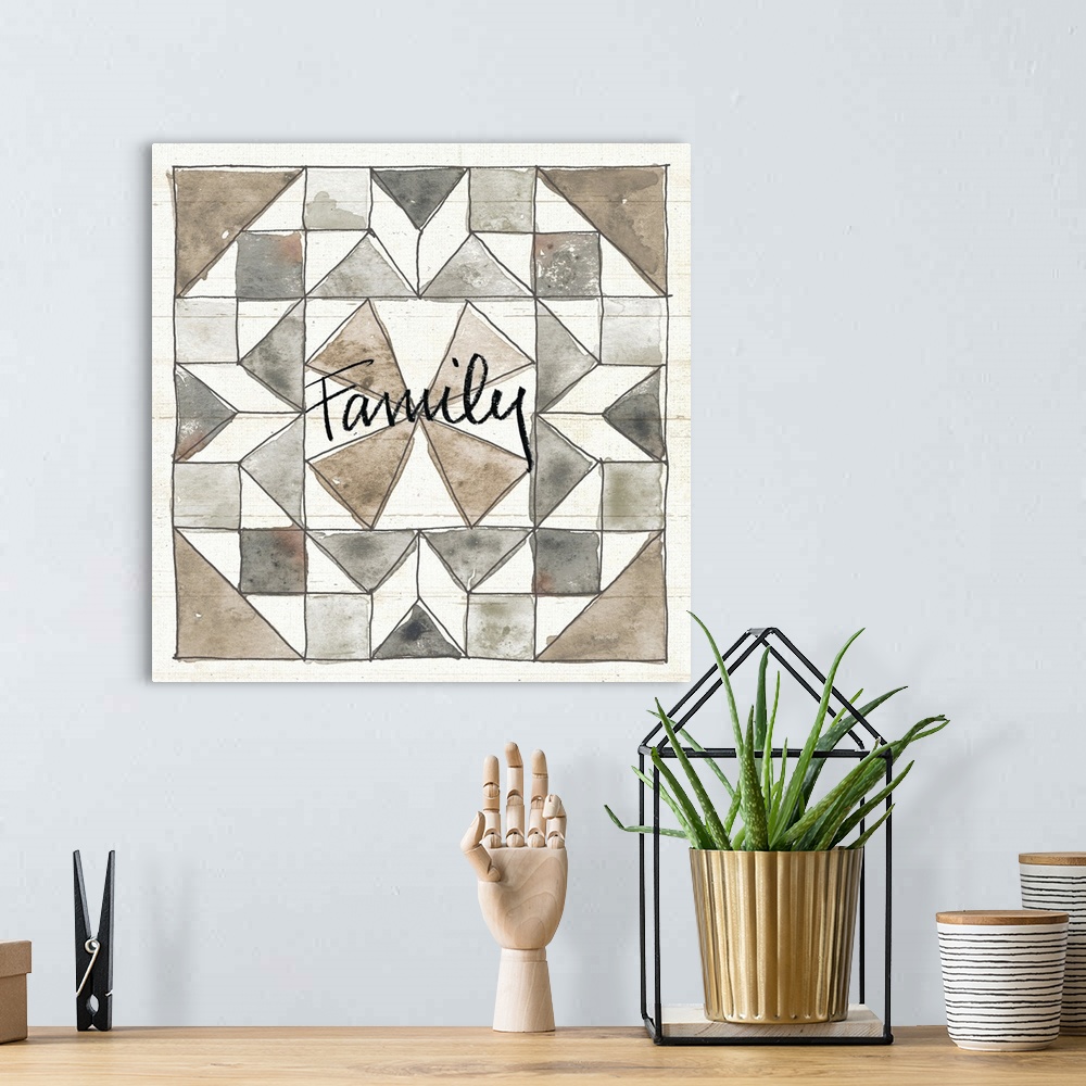 A bohemian room featuring "Family" with a watercolor quilt box design in neutral colors on a wood panel backdrop.