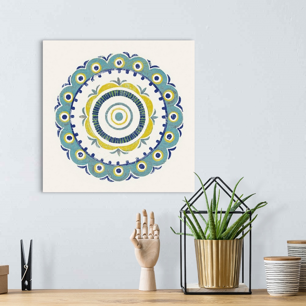 A bohemian room featuring Square decor with a mandala design in the center made in shades of blue, green, and yellow on a w...