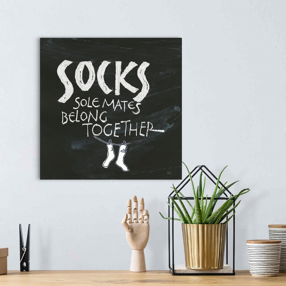 A bohemian room featuring "Socks, Sole Mates Belong Together" on a chalkboard backdrop.