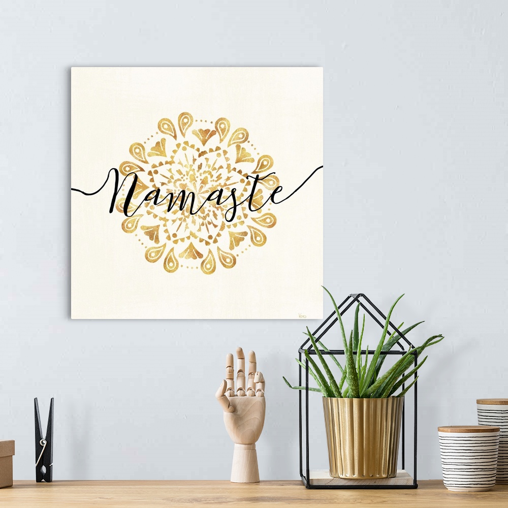 A bohemian room featuring Shiny gold mandala on a neutral background with the word "Namaste" written through the center.