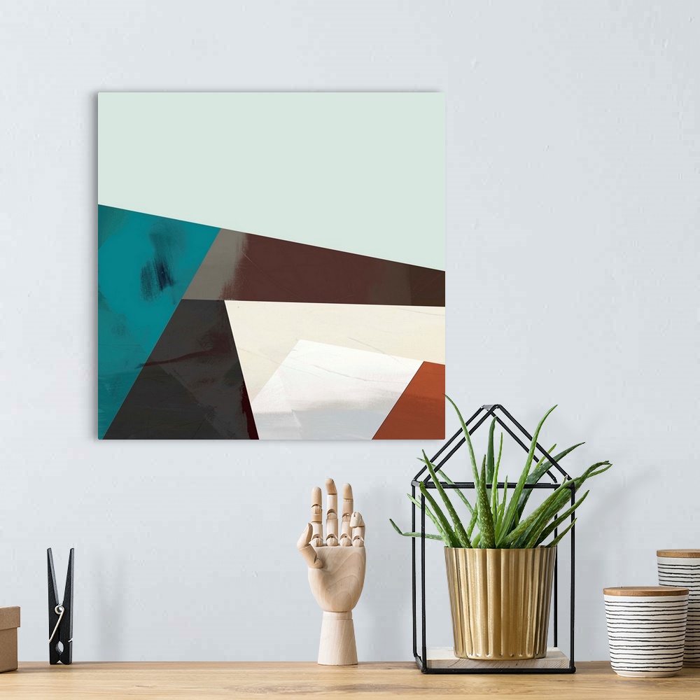 A bohemian room featuring Modern abstract artwork of angular shapes in brown, red, and teal.