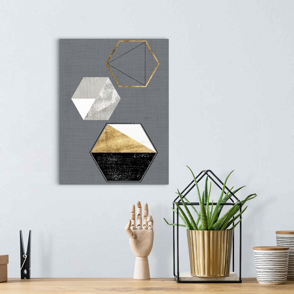 A bohemian room featuring Abstract geometric artwork of triangular and hexagonal shapes in grey and gold.