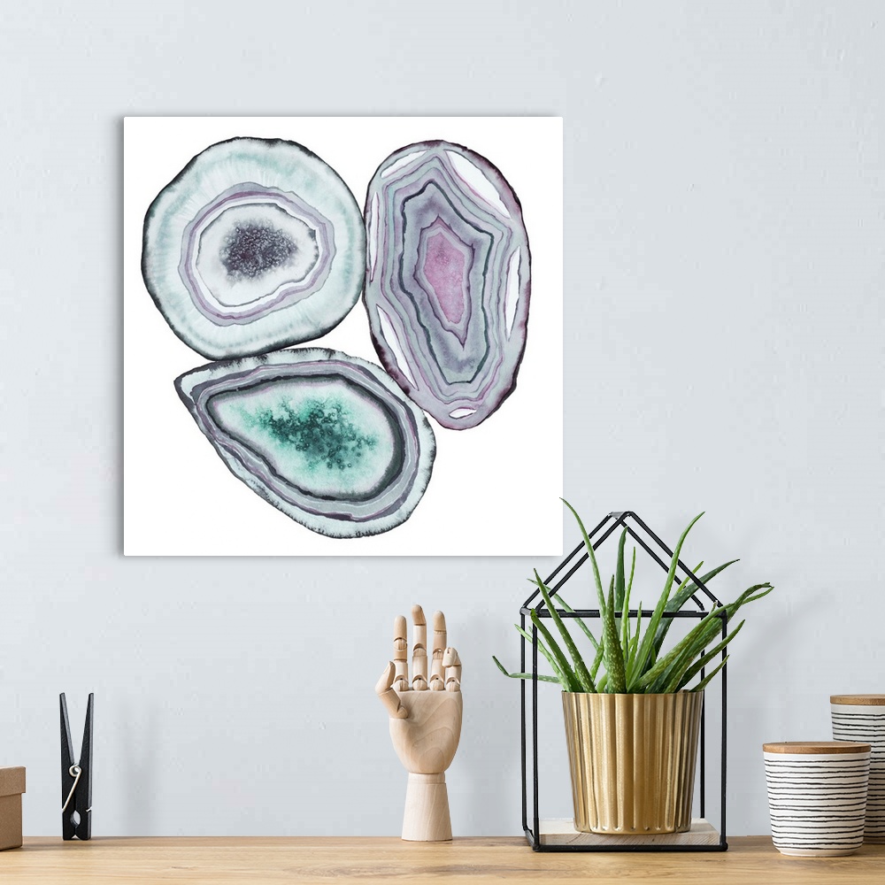 A bohemian room featuring Square watercolor artwork of geode rocks in green, purple and blue on a white background.