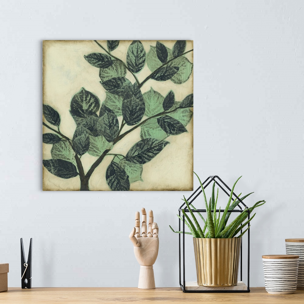 A bohemian room featuring Home decor artwork of muted green leaves on a twig against a light pale green background.