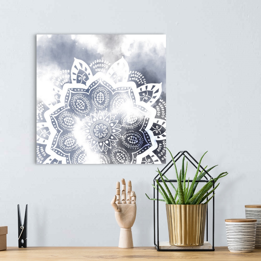 A bohemian room featuring Decorative image of a mandala pattern in white over dark blue, fading into white.