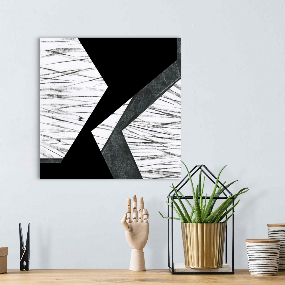 A bohemian room featuring Black and white geometric abstract painting on a square background.